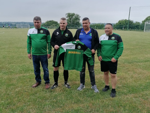 George Botis - owner of Borza Takeaway, Rathvilly presents set of jerseys to the O35's